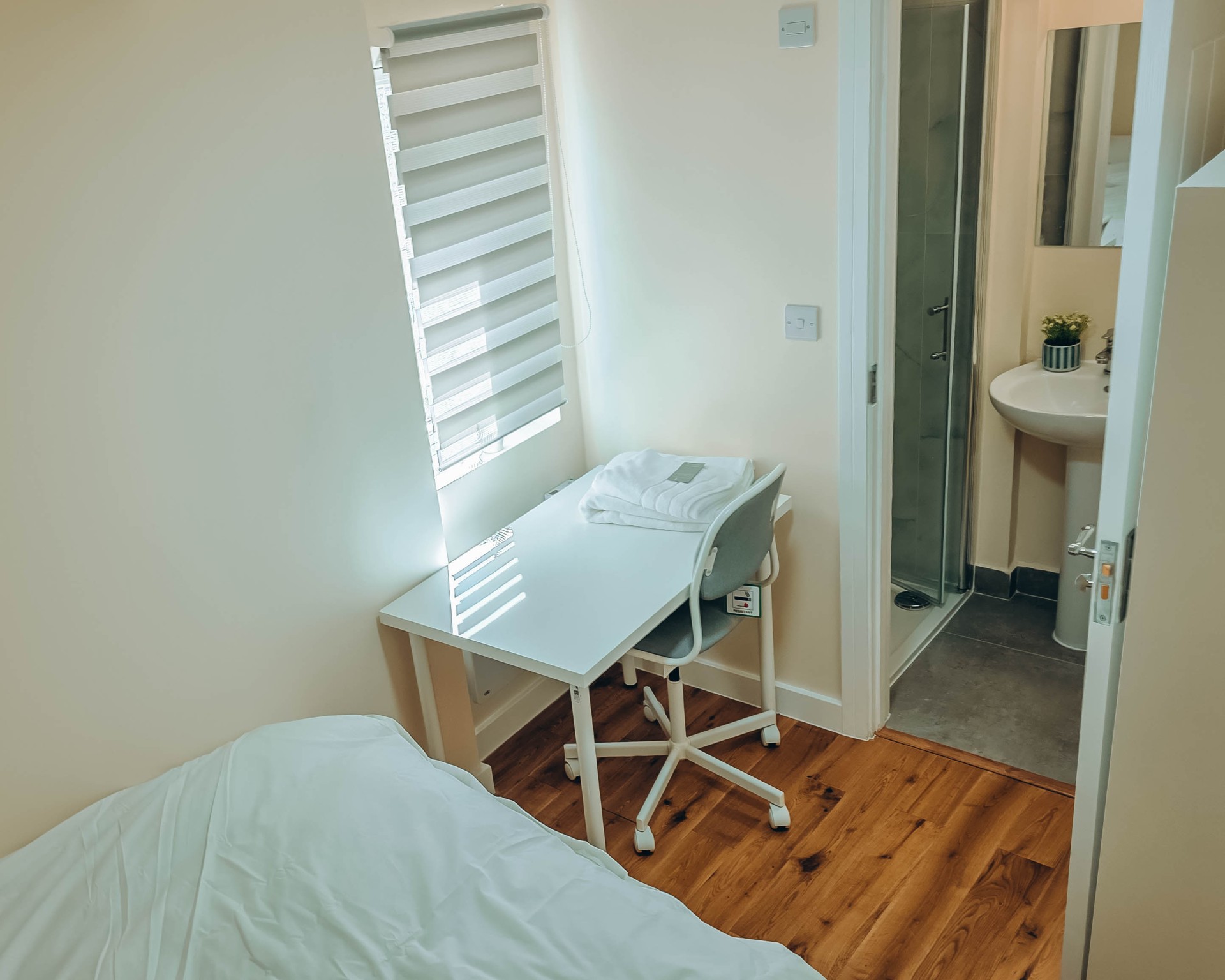 Single en-suite bedroom at a Kope-Medics supported living home with desk and shower room