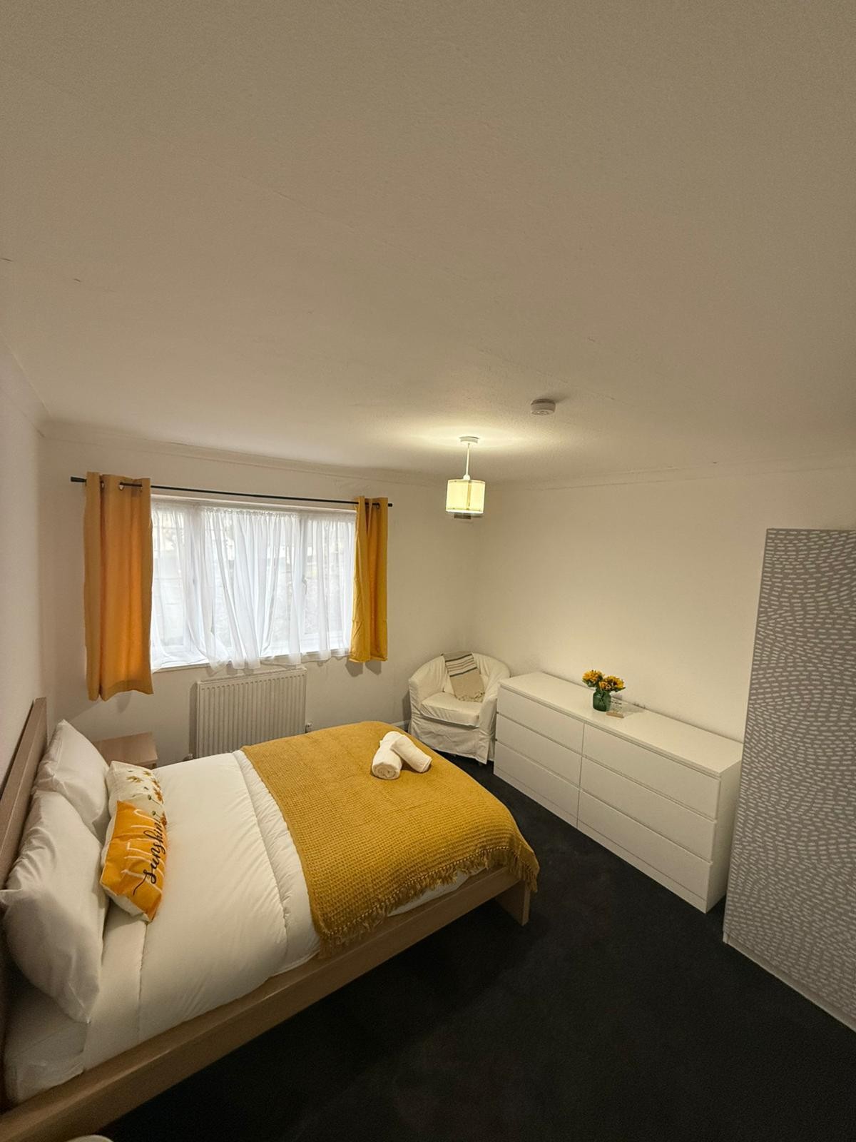 Warm and welcoming bedroom at a Kope-Medics supported living home with double bed and storage