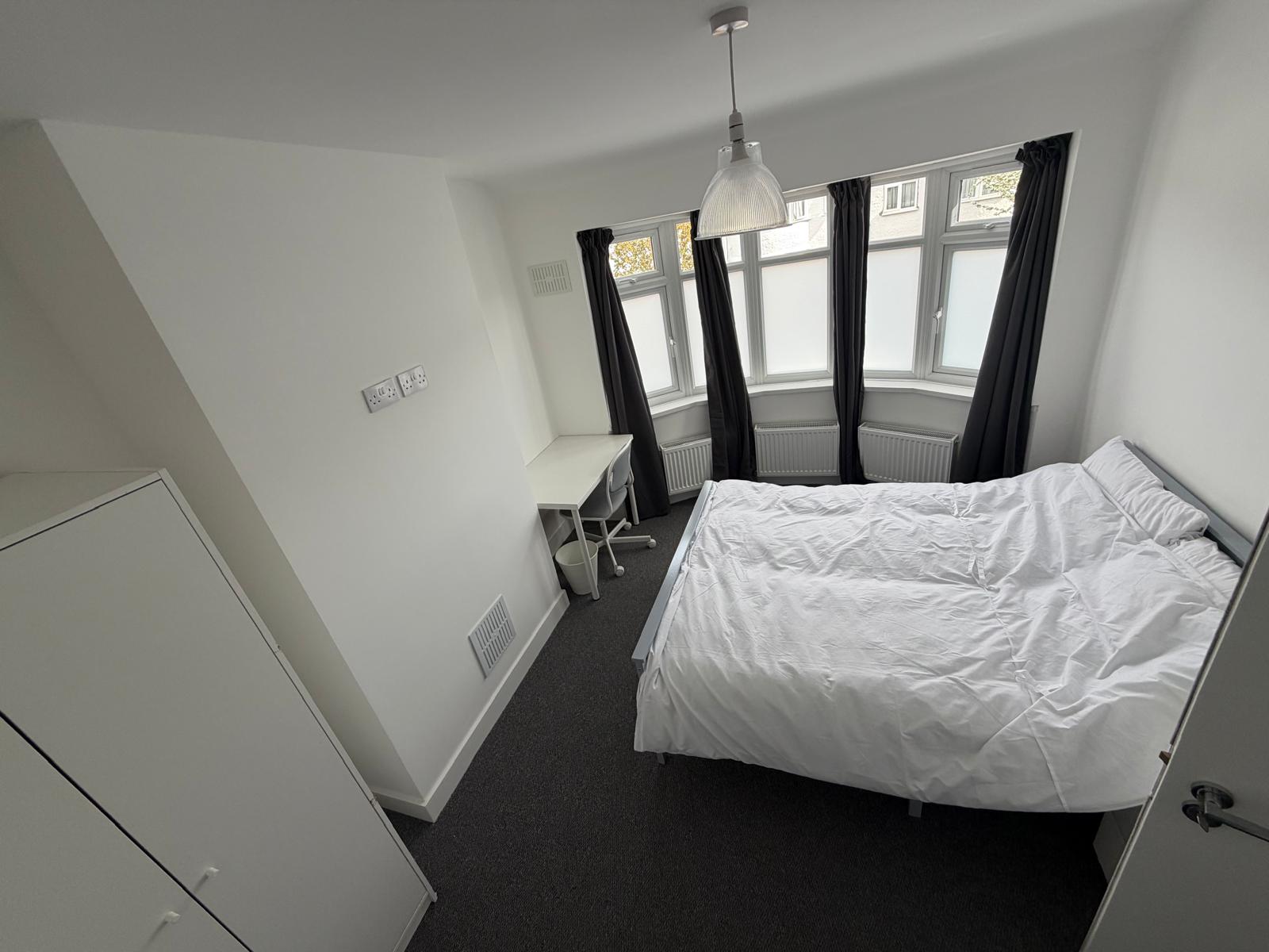 Light bay-window bedroom at a Kope-Medics supported living home